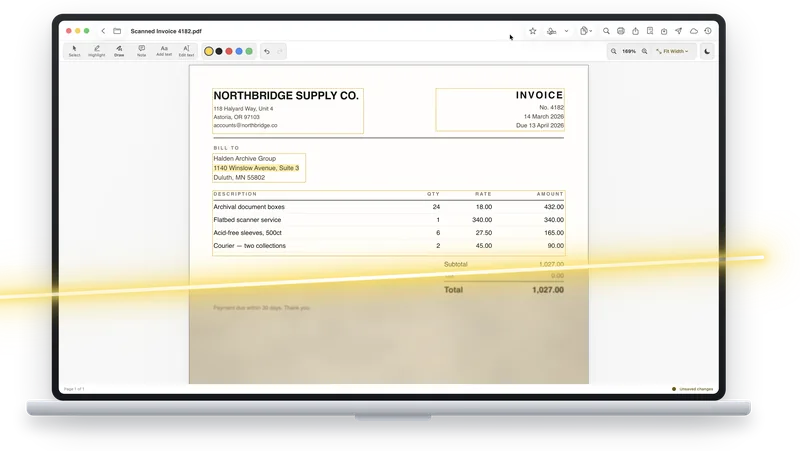 A scanned invoice open in ASAPDF on a laptop, with a light beam passing over the page.