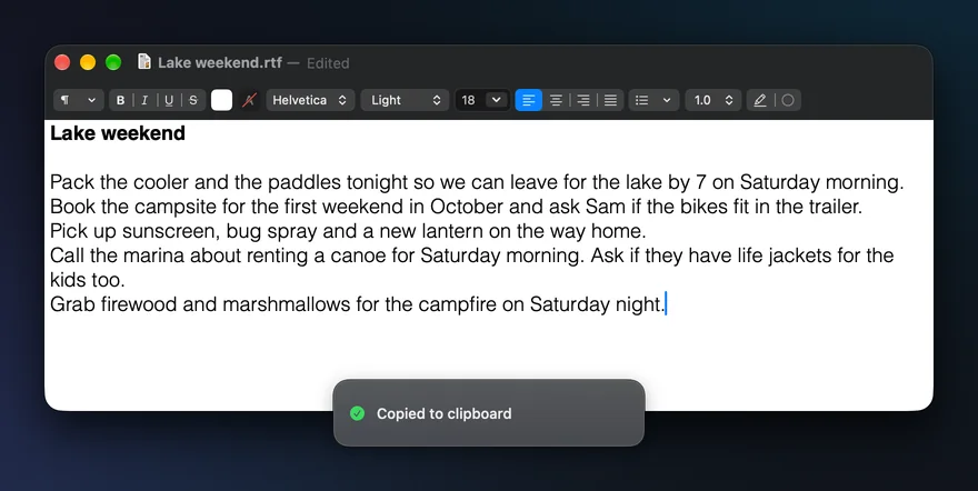 The same note a moment later: Grab firewood and marshmallows for the campfire on Saturday night, pasted with ⌘V on the new line, and SayCopyPaste’s pill: Copied to clipboard.